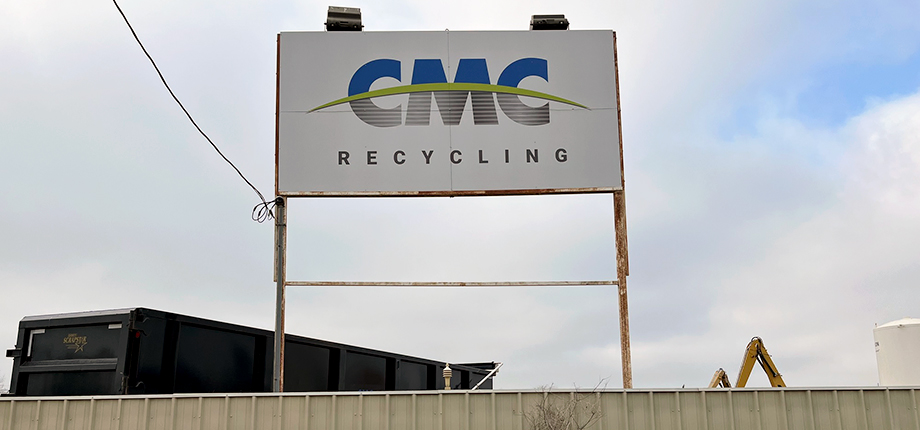CMC Recycling sign. Outdoors, elevated.