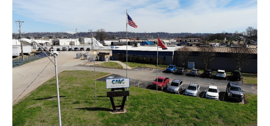 Outside view of CMC Recycling Chattanooga sign with recycling facility in background.